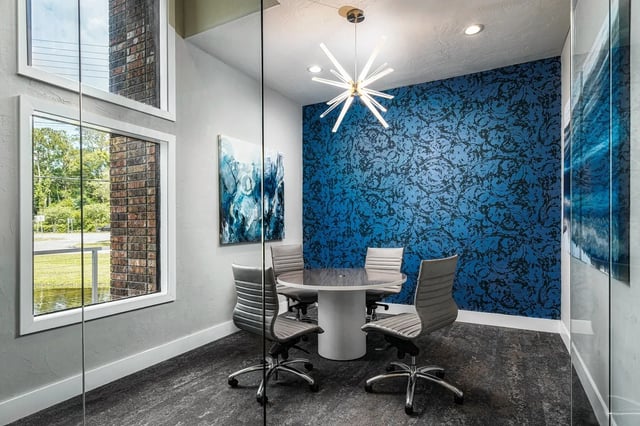 Round table four chairs blue wall study area at Oxford Manor in Gainesville Student Accommodation