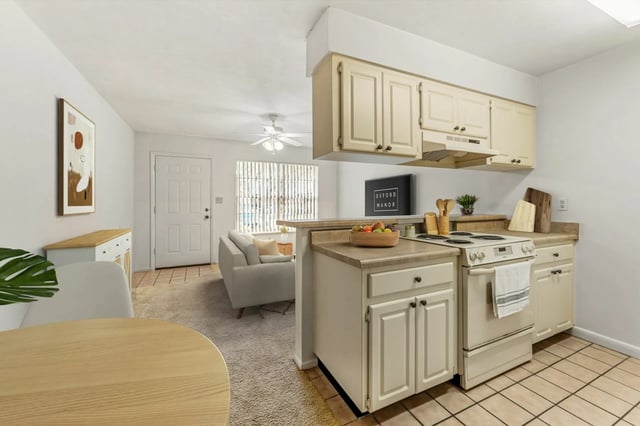 Open plan kitchen and living area with sofa Image Type at Oxford Manor in Gainesville Student Accommodation
