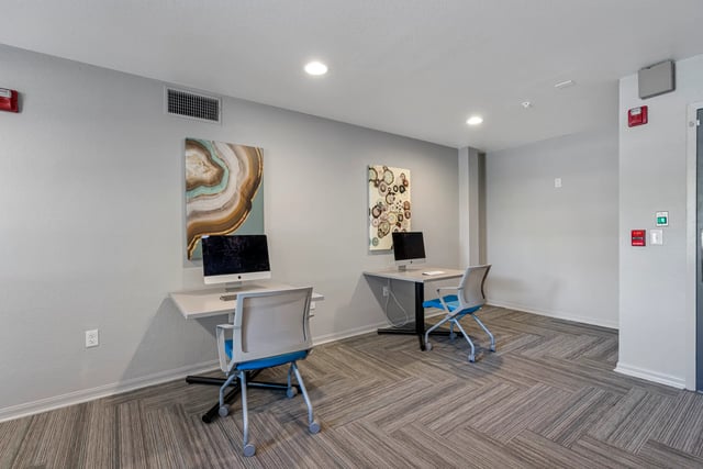 Computers and chairs in a study area at VUE Tampa in Tampa Student Accommodation
