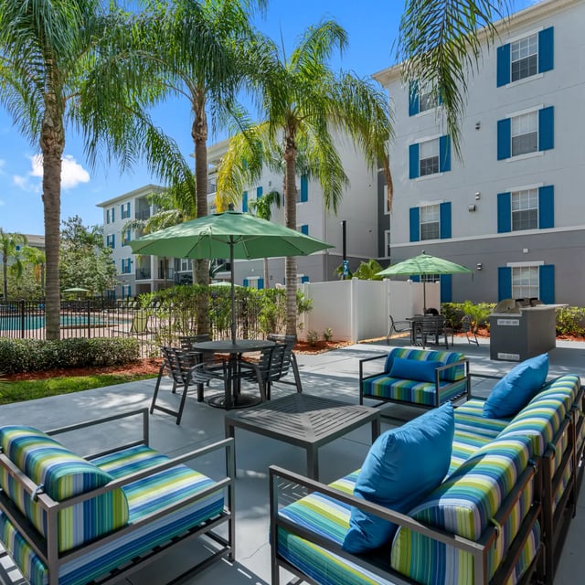 Colorful striped couches and chairs outdoor seating patio exterior at VUE Tampa in Tampa Student Accommodation