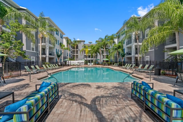 Pool with lounge chairs and sofas exterior at VUE Tampa in Tampa Student Accommodation
