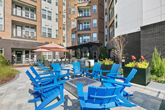 Blue chairs around fire pit outdoor living area at Monarch in Gainesville Student Accommodation