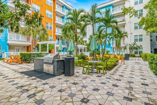 Grill tables chairs umbrellas exterior at IQ Apartments in Tampa Student Accommodation