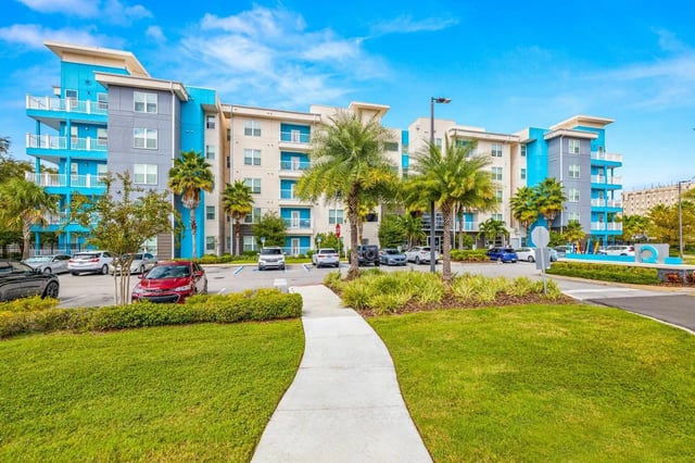 Modern apartment building with balconies and parking exterior at IQ Apartments in Tampa Student Accommodation