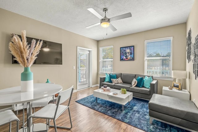 Dining table couch coffee table rug living room at IQ Apartments in Tampa Student Accommodation