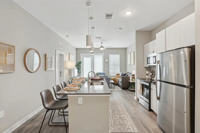 Island bar with chairs and kitchen living area at The Metropolitan Tampa in Tampa Student Accommodation