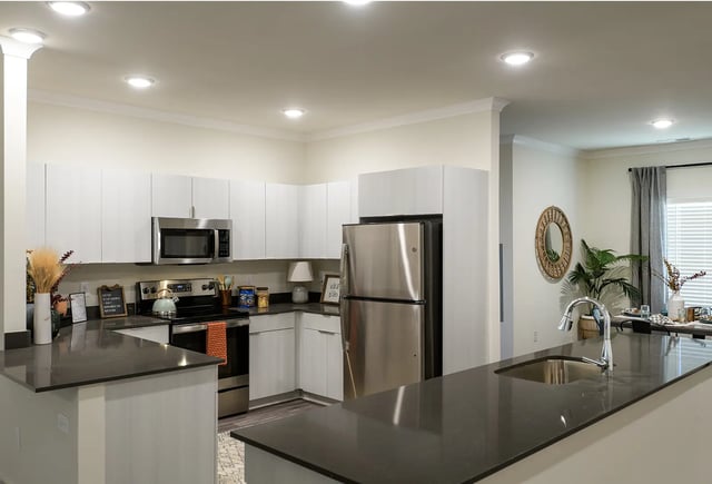 Modern kitchen with stainless steel appliances kitchen island living room at The Metropolitan Tampa in Tampa Student Accommodation