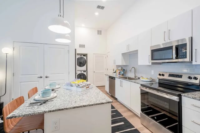 Granite island with chairs washer dryer kitchen kitchen at The Accolade Collegiate Village East in Orlando Student Accommodation