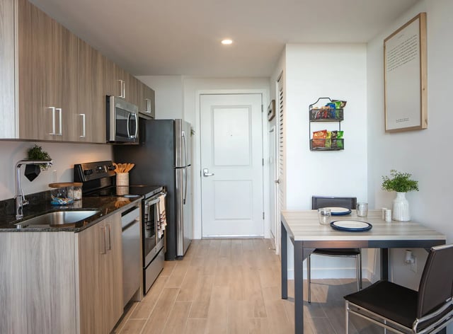 Modern apartment kitchen with dining table and chairs Kitchen at The One at University City in Miami Student Accommodation