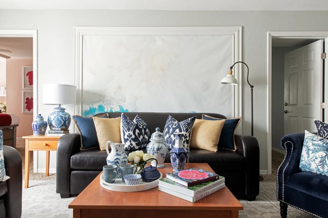 Dark leather sofa with blue pillows living room at The Social Tampa in Lutz Student Accommodation