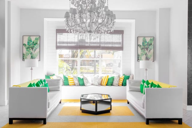 White sofas green yellow pillows coffee table living room at The Social Tampa in Lutz Student Accommodation