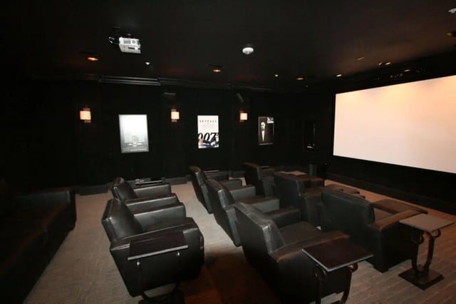 Black theater seats projector and screen Movie Room at The Flats at 4200 in Tampa Student Accommodation