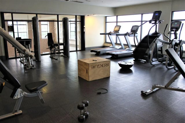 Gym equipment treadmills stairs bench weights workout box gym at The Flats at 4200 in Tampa Student Accommodation