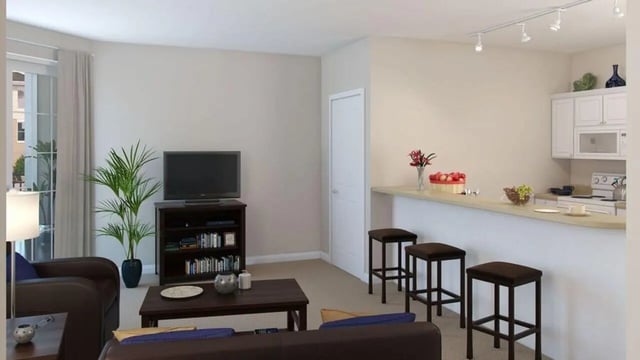 Sofa TV bookcase plant bar stools kitchen living room at The Flats at 4200 in Tampa Student Accommodation
