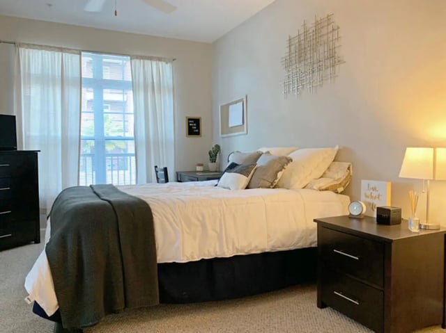 Bed nightstand desk chair and dresser bedroom at The Flats at 4200 in Tampa Student Accommodation