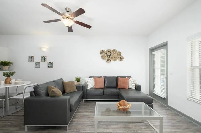 L-shaped sectional sofa coffee table living room at The Enclave in Gainesville Student Accommodation