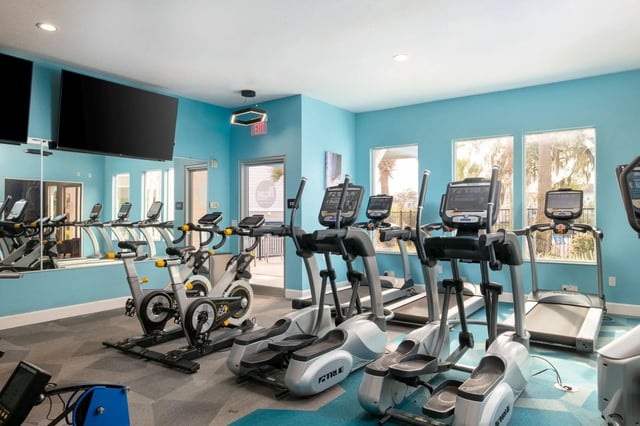 Elliptical machines treadmills and stationary bikes fitness room at The Enclave in Gainesville Student Accommodation