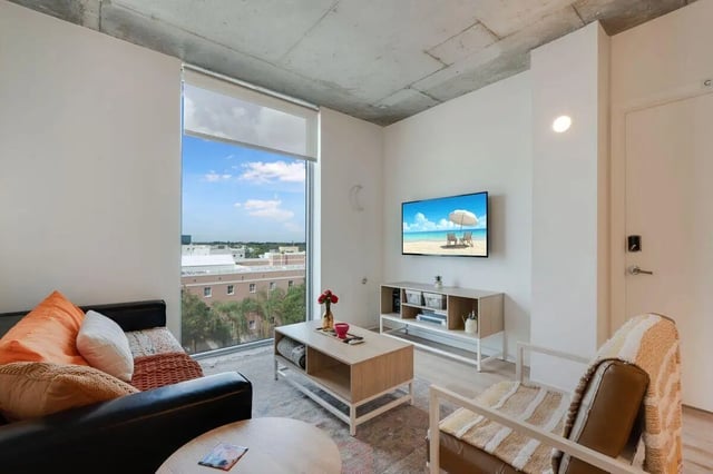 Sofa coffee table TV and chair living room at VOX Miami in Miami Student Accommodation