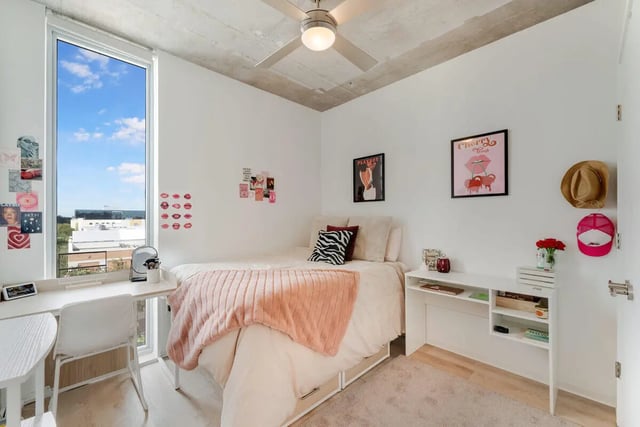 Bed with pink throw desk and window bedroom at VOX Miami in Miami Student Accommodation