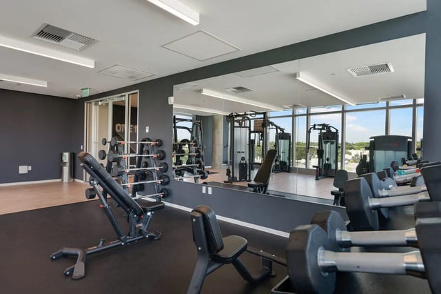 Dumbbells weights bench and machines gym area at VOX Miami in Miami Student Accommodation