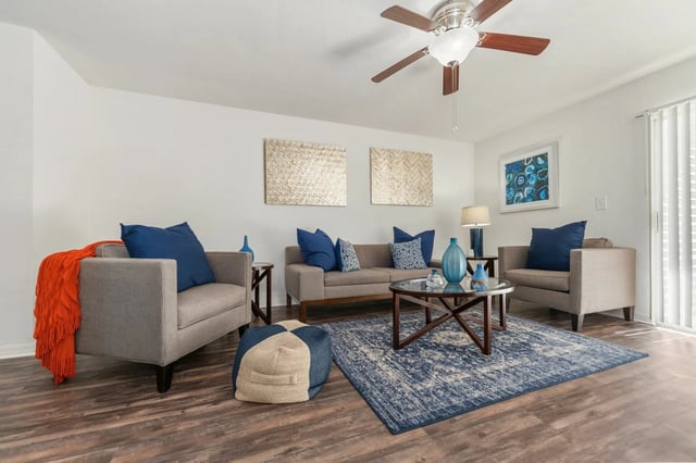 Sofa chairs coffee table blue rug living room at Greenwich Green Aspen Ridge in Gainesville Student Accommodation
