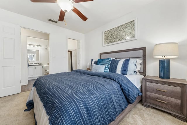 Blue striped bedding grey headboard nightstand bedroom at Greenwich Green Aspen Ridge in Gainesville Student Accommodation