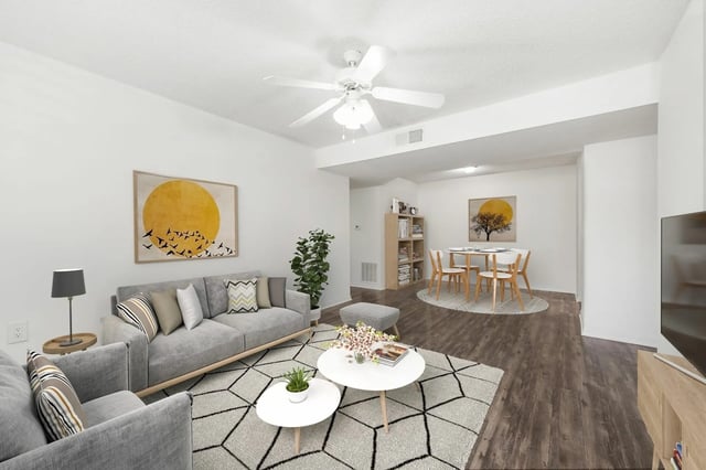 Sofa artwork plant table and chairs living area at Greenwich Green Aspen Ridge in Gainesville Student Accommodation