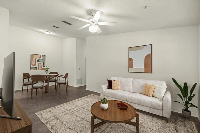 Sofa coffee table rug abstract art dining set living room at Greenwich Green Aspen Ridge in Gainesville Student Accommodation