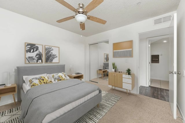 Bed ceiling fan framed art dresser and doorway Bedroom at Greenwich Green Aspen Ridge in Gainesville Student Accommodation