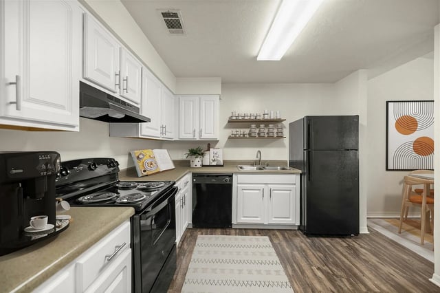Modern kitchen with black appliances white cabinets kitchen at Greenwich Green Aspen Ridge in Gainesville Student Accommodation