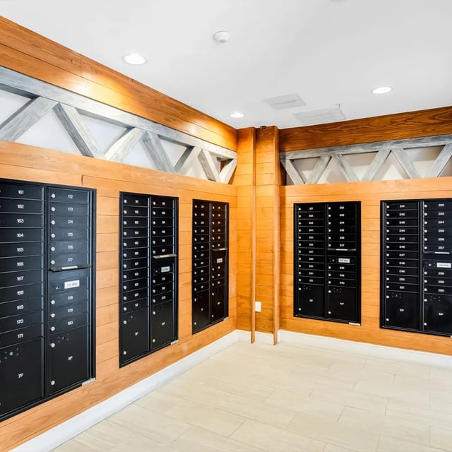 Mailboxes with numbered doors in wooden hallway mail area at Halo 46 in Tampa Student Accommodation