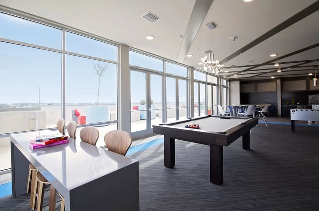 Pool table with chairs and foosball game room at The Standard at Gainesville in Gainesville Student Accommodation