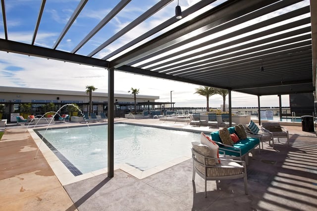 Pool with lounge chairs and fountains outdoor living area at The Standard at Gainesville in Gainesville Student Accommodation