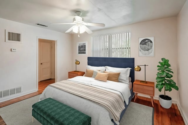 Bed with nightstands art plant Bedroom at College Manor in Gainesville Student Accommodation