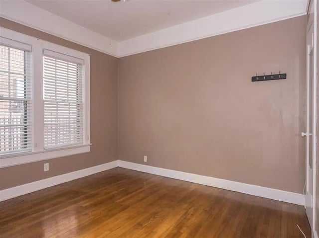 Empty room with windows and wall hooks bedroom at Alligator Alley Apartments in Gainesville Student Accommodation