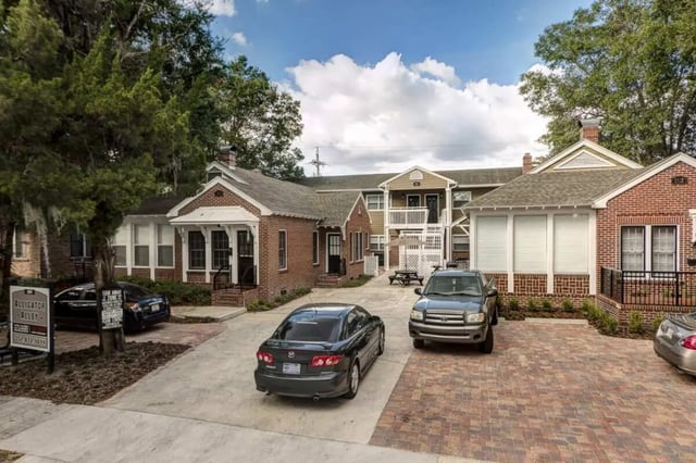 Apartment buildings with cars parked outside exterior at Alligator Alley Apartments in Gainesville Student Accommodation