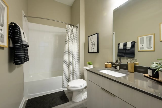 White bathtub toilet vanity sink bathroom at The Metropolitan Gainesville in Gainesville Student Accommodation