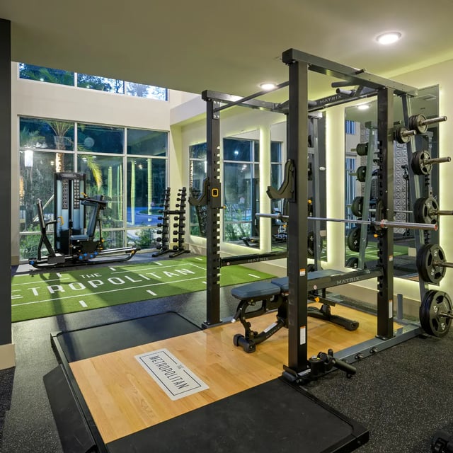 Gym with weight rack dumbbells and machines fitness area at The Metropolitan Gainesville in Gainesville Student Accommodation