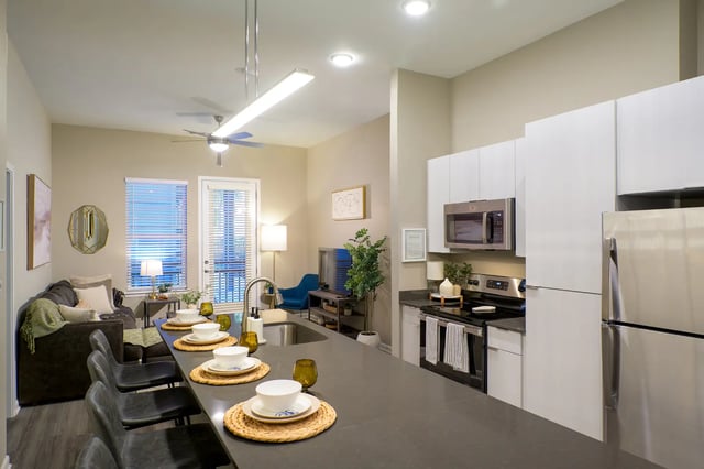 Kitchen island with seating living room and appliances living room at The Metropolitan Gainesville in Gainesville Student Accommodation