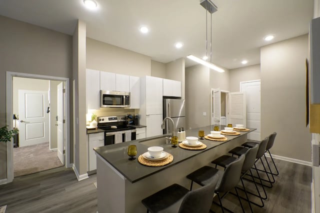 Modern kitchen with island and stools kitchen at The Metropolitan Gainesville in Gainesville Student Accommodation