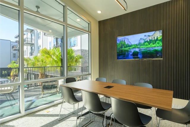 Conference table chairs and television common area at The Metropolitan Gainesville in Gainesville Student Accommodation