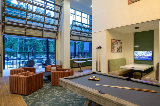 Pool table sofas and seating area living room at The Metropolitan Gainesville in Gainesville Student Accommodation