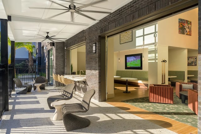 Patio seating bar area with lounge and TV area living room at The Metropolitan Gainesville in Gainesville Student Accommodation