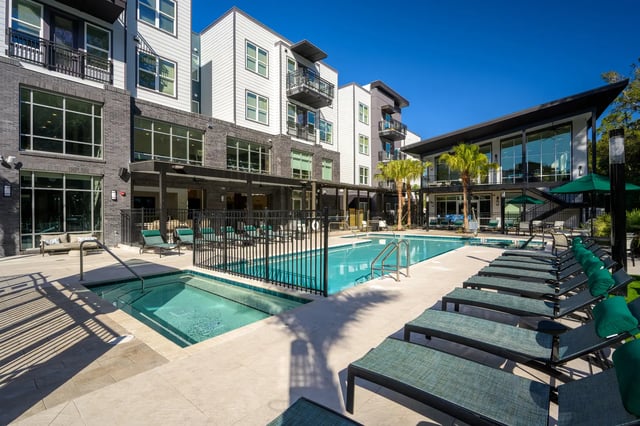 Outdoor pool hot tub lounge chairs building exterior at The Metropolitan Gainesville in Gainesville Student Accommodation