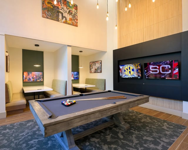 Pool table with seating and televisions entertainment area at The Metropolitan Gainesville in Gainesville Student Accommodation