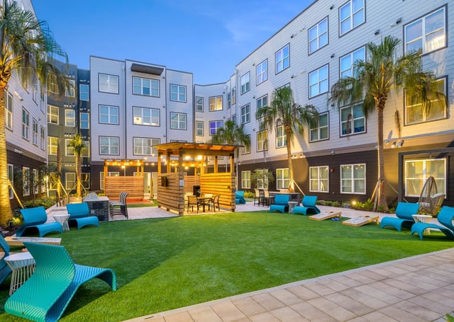 Blue loungers fire pit grill courtyard exterior at The Metropolitan Gainesville in Gainesville Student Accommodation