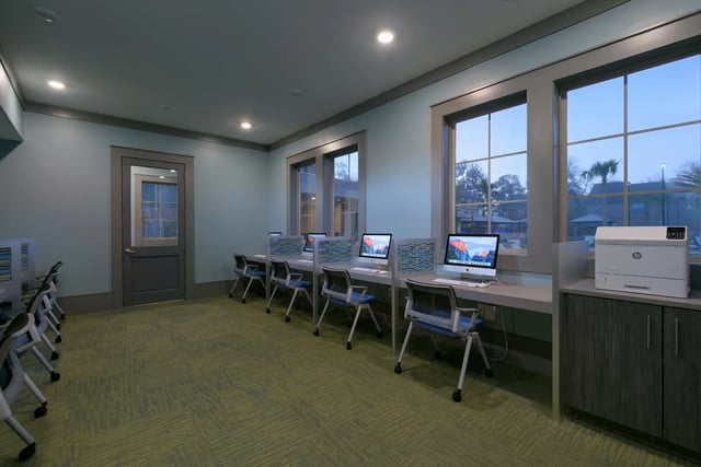 Computer workstations and printer in communal study area at The Retreat at Gainesville in Gainesville Student Accommodation