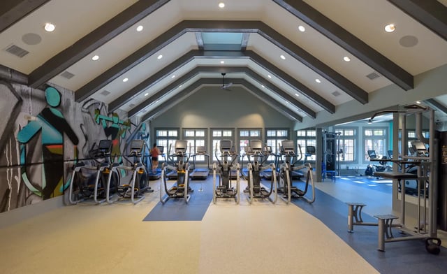 Gym equipment with graffiti wall gym area at The Retreat at Gainesville in Gainesville Student Accommodation