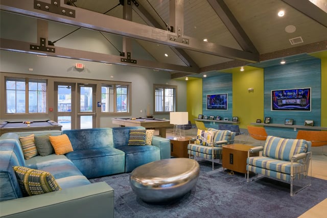 Blue sectional sofa pool tables two TVs lounge area at The Retreat at Gainesville in Gainesville Student Accommodation