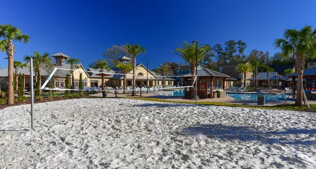 Volleyball court pool and buildings exterior at The Retreat at Gainesville in Gainesville Student Accommodation